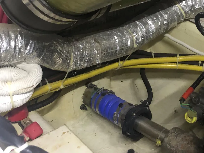 Slide: The Image of Engine room of a 2006 Carver 43 Motor Yacht with visible hoses and mechanical components. - 24