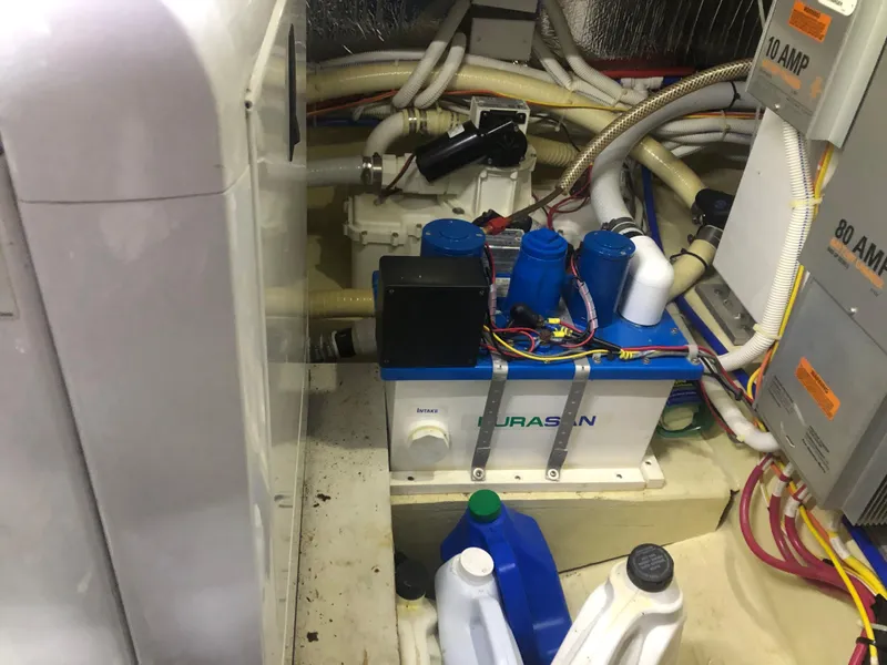 Slide: The Image of Engine room of a 2006 Carver 43 Motor Yacht with various mechanical components and wiring. - 34