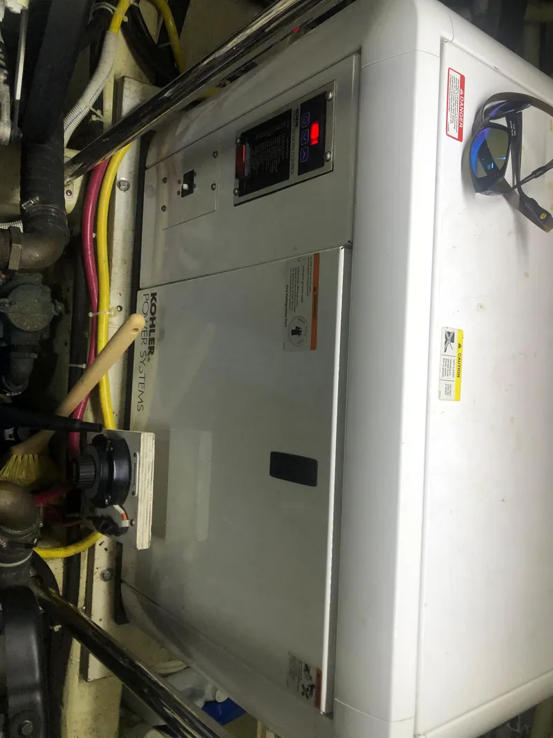 Slide: The Image of 2006 Carver 43 Motor Yacht engine room with generator and wiring. - 35