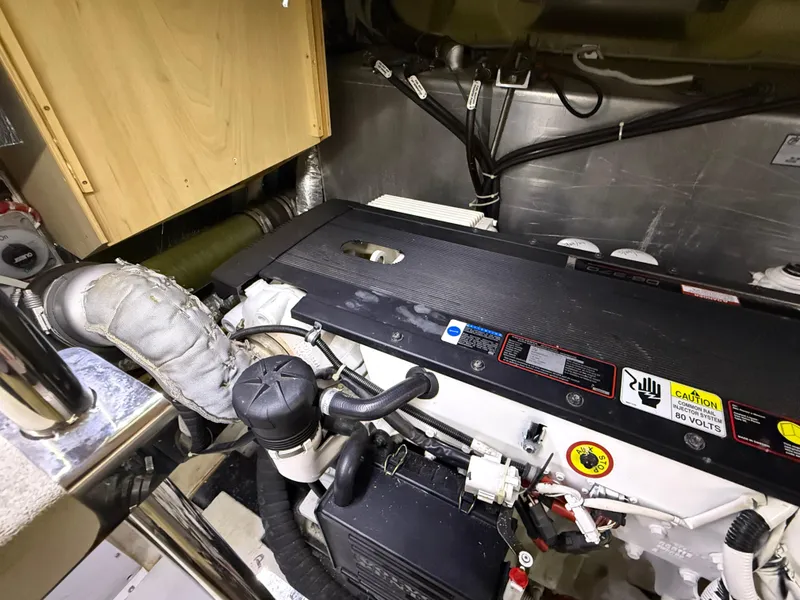 Slide: The Image of Engine room of 2006 Carver 43 Motor Yacht, showcasing detailed mechanical components. - 44