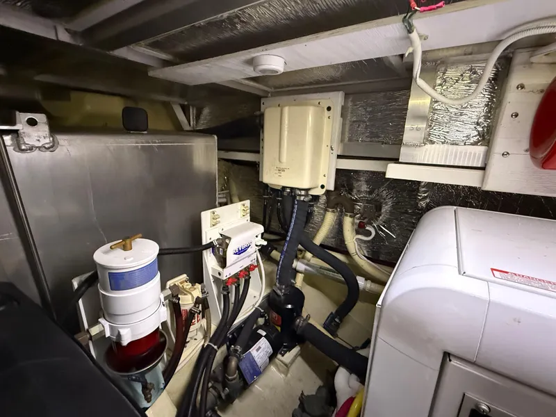 Slide: The Image of Engine room of a 2006 Carver 43 Motor Yacht with various mechanical components. - 47