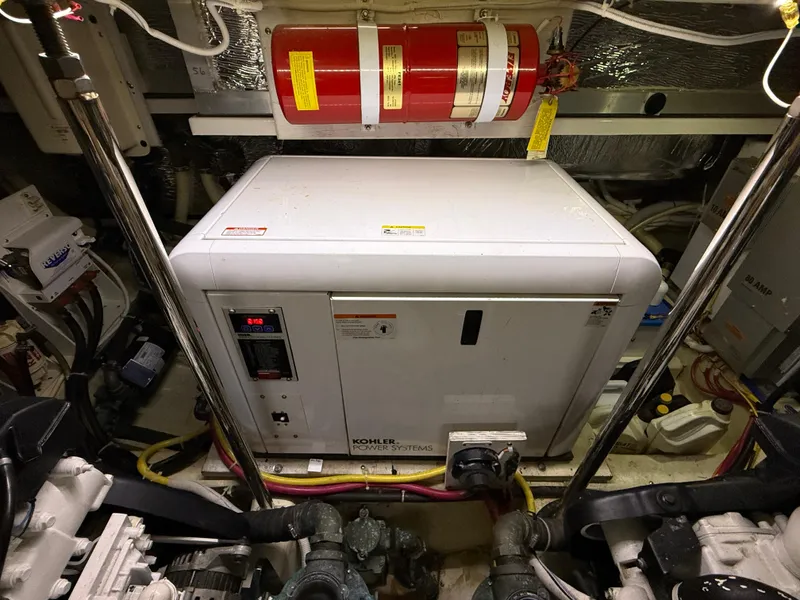 Slide: The Image of Engine room of 2006 Carver 43 Motor Yacht with Kohler generator and fire extinguisher. - 49
