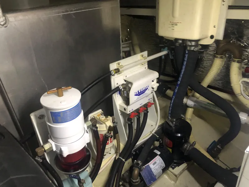 Slide: The Image of Engine room of 2006 Carver 43 Motor Yacht with mechanical components and hoses. - 32