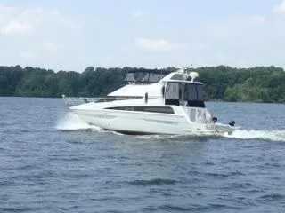 Slide: The Image of 2006 Carver 43 Motor Yacht cruising on a lake with forested shoreline. - 4