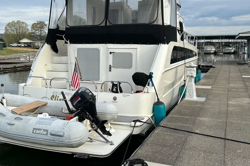 Slide: The Image of 2006 Carver 43 Motor Yacht docked with inflatable boat and American flag. - 5