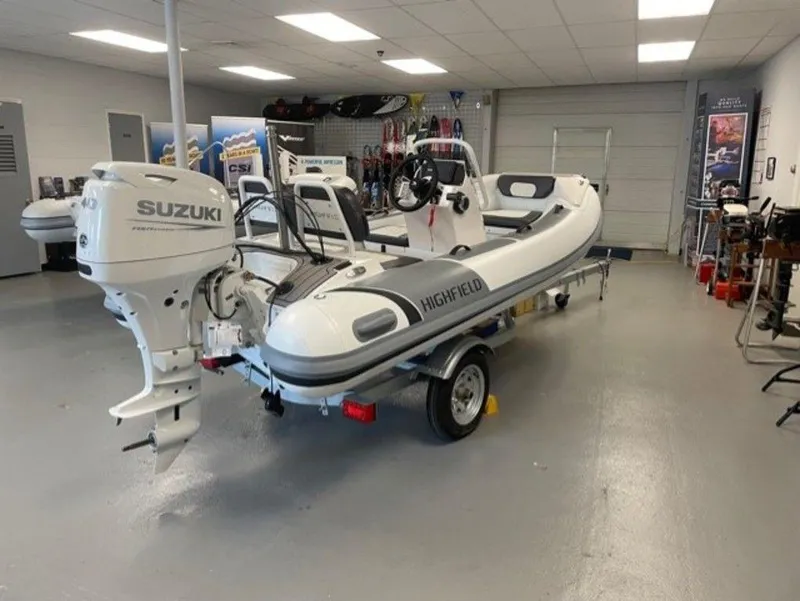 Slide: The Image of 2025 Highfield Sport 390 boat with Suzuki engine on display in showroom. - 3