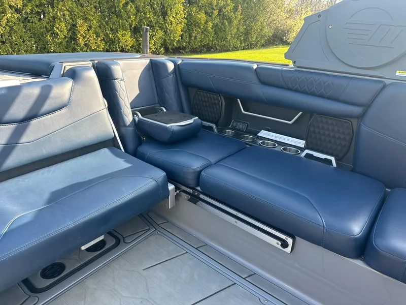 Slide: The Image of Luxurious interior seating of a 2020 Malibu M240 boat with blue upholstery. - 10