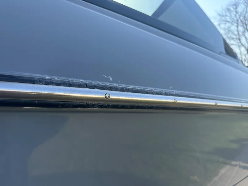 Slide: The Image of 2020 Malibu M240 boat close-up, showcasing sleek design and metallic detailing. - 18