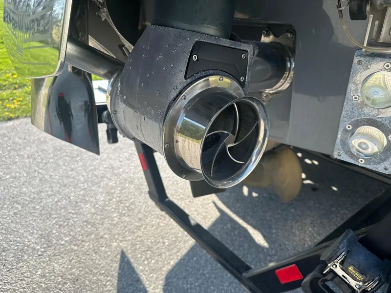 Slide: The Image of Close-up of a 2020 Malibu M240 boat exhaust system with a polished metal finish. - 23