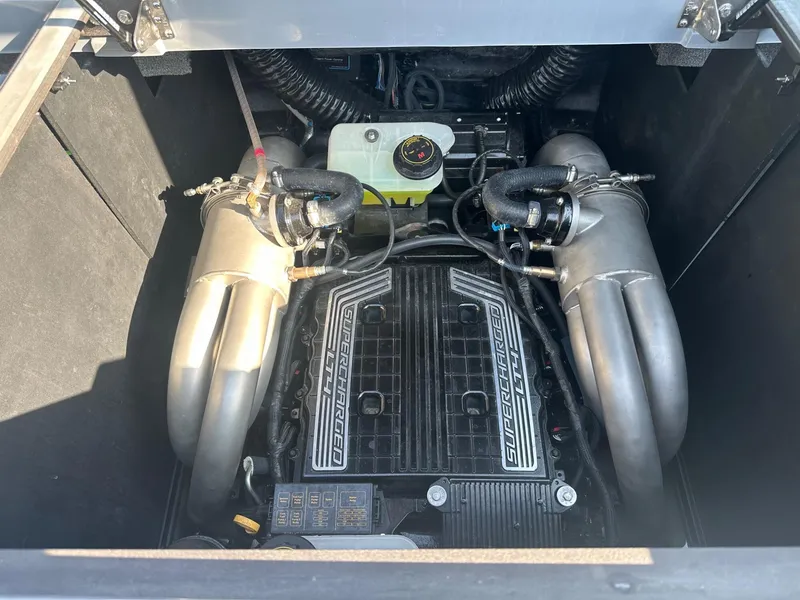 Slide: The Image of 2020 Malibu M240 engine compartment with dual exhaust system and visible components. - 25