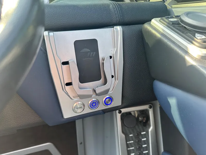 Slide: The Image of Control panel of a 2020 Malibu M240 boat with buttons and sleek design. - 29