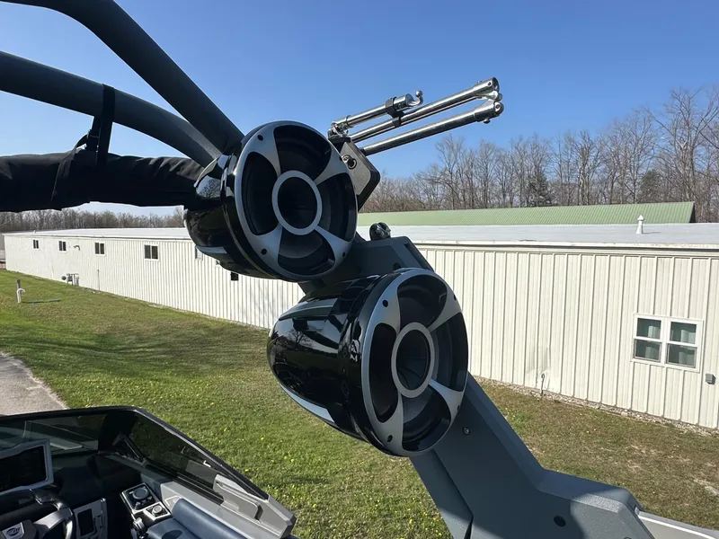 Slide: The Image of 2020 Malibu M240 boat speakers and wakeboard rack against a clear sky. - 32