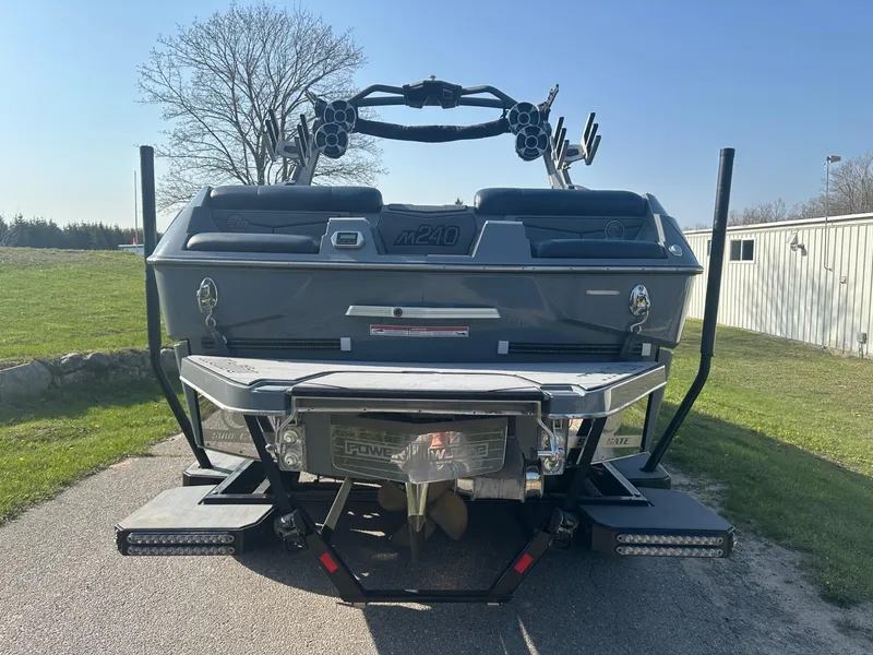 Slide: The Image of 2020 Malibu M240 boat rear view with wakeboard tower and swim platform. - 7