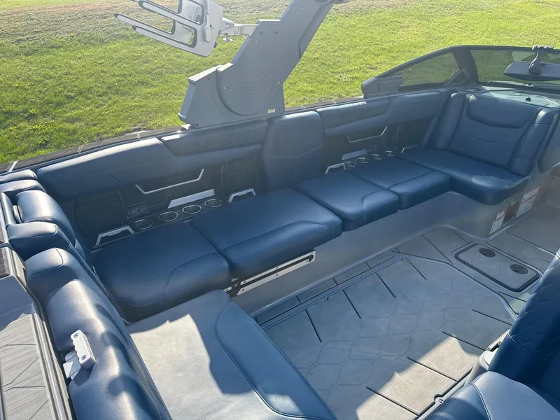 Slide: The Image of 2020 Malibu M240 boat interior with blue seating and modern design. - 8