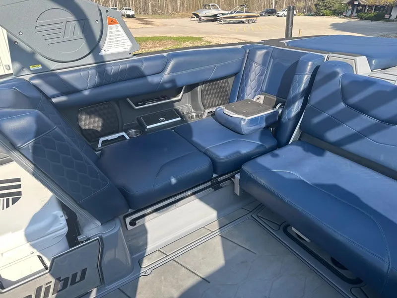 Slide: The Image of 2020 Malibu M240 boat interior with blue leather seating and modern design. - 9