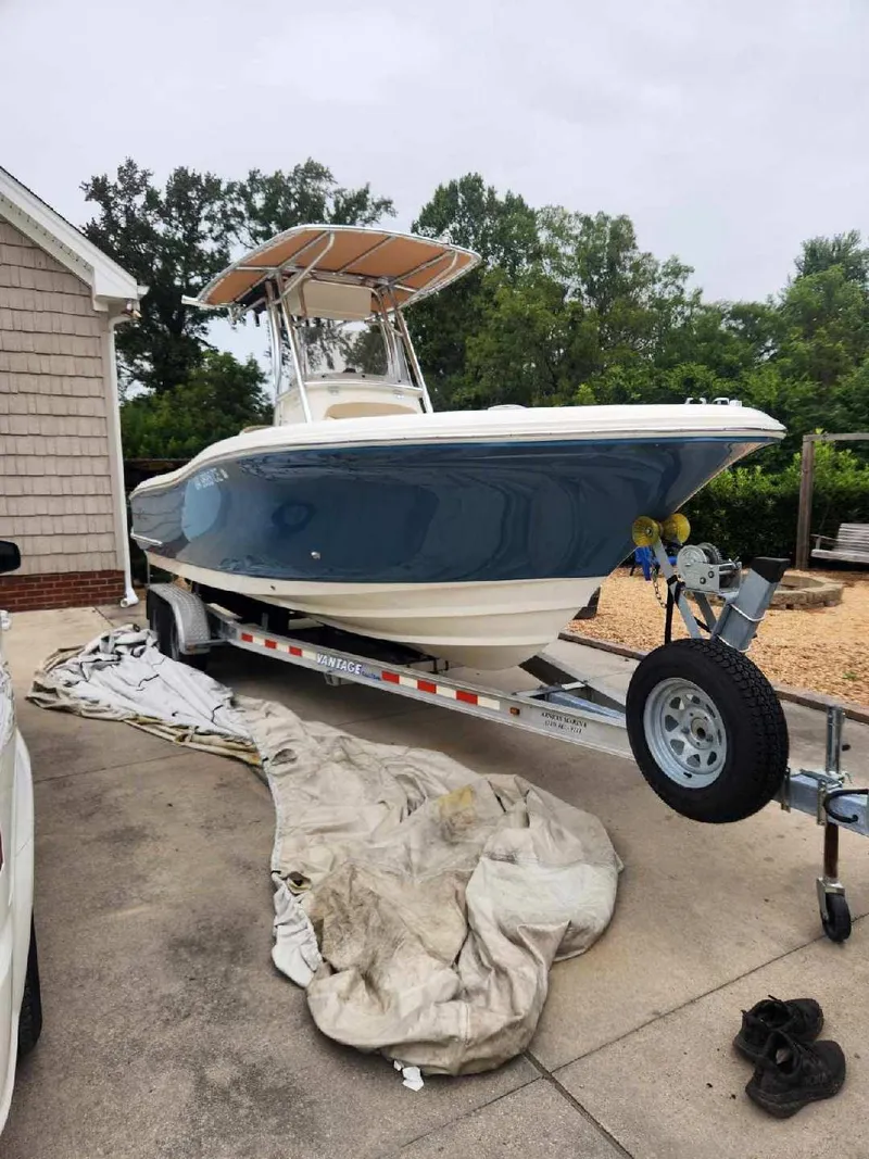 Slide: The Image of 2019 Pioneer 222 Sportfish boat on trailer, parked in driveway. - 2