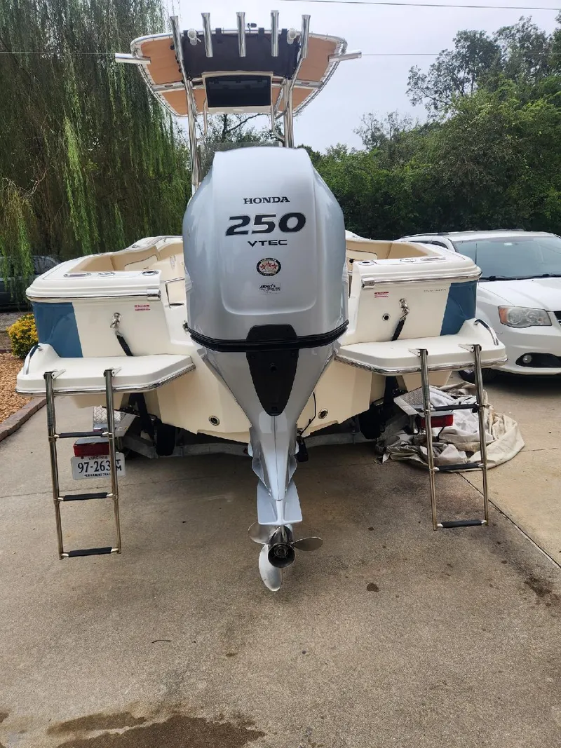 Slide: The Image of 2019 Pioneer 222 Sportfish boat with Honda 250 VTEC engine, parked on driveway. - 4