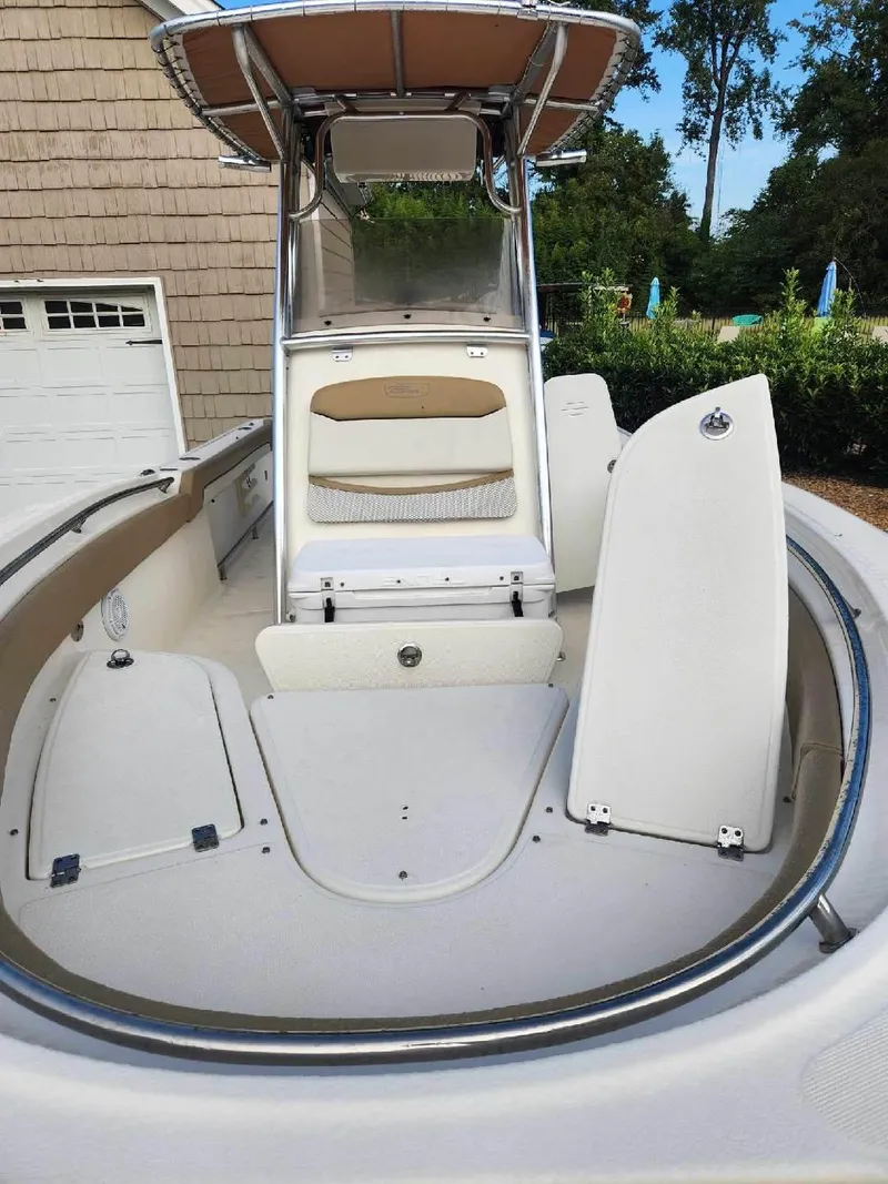 Slide: The Image of 2019 Pioneer 222 Sportfish boat with open deck and storage compartments. - 9