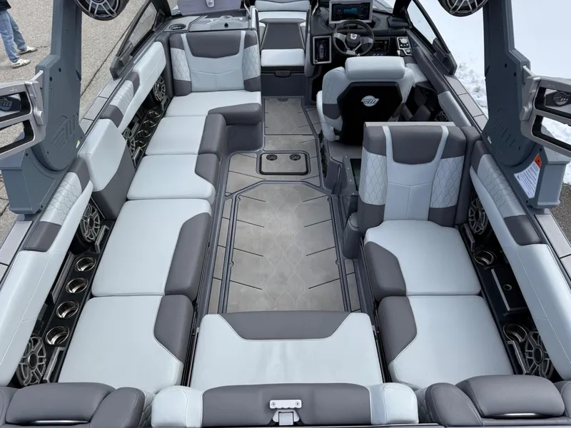 Slide: The Image of 2021 Malibu M240 boat interior with spacious seating and modern design. - 10