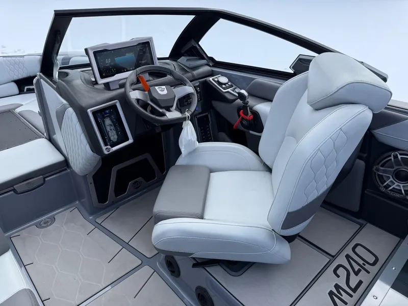 Slide: The Image of 2021 Malibu M240 boat interior with modern dashboard and luxurious seating. - 16