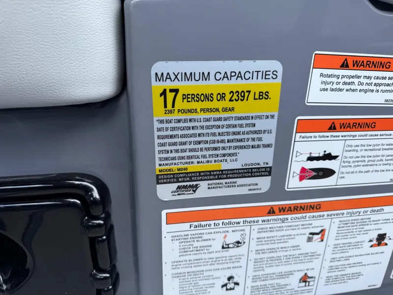 Slide: The Image of 2021 Malibu M240 capacity label, maximum 17 persons or 2397 lbs, safety warnings included. - 22