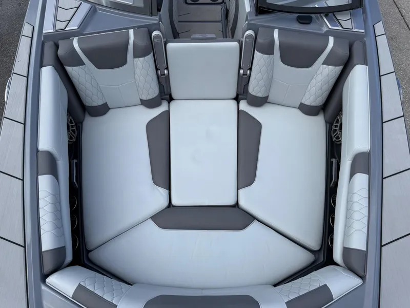 Slide: The Image of 2021 Malibu M240 boat interior with gray and white cushioned seating. - 24
