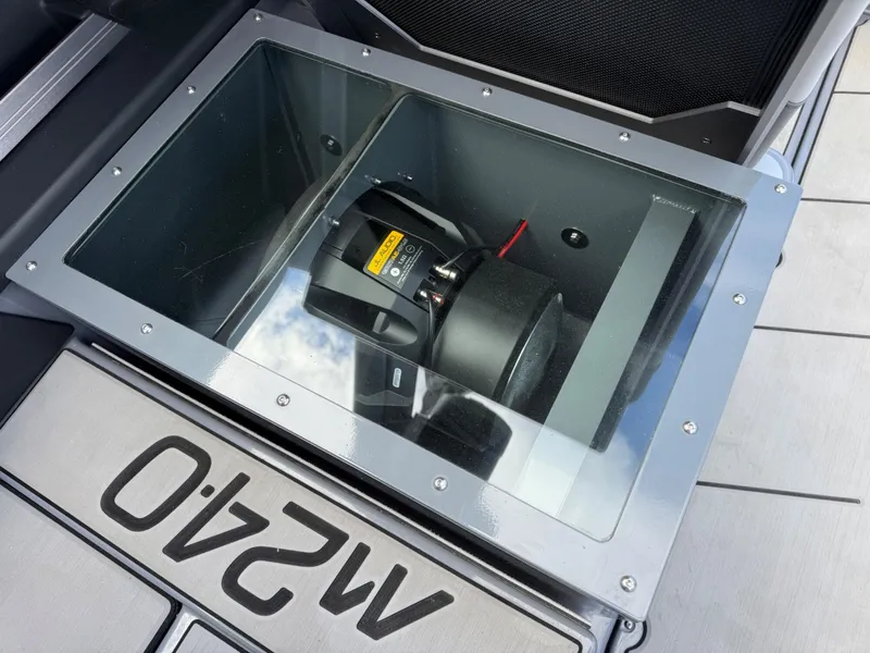 Slide: The Image of 2021 Malibu M240 boat subwoofer in glass enclosure, showcasing premium audio system. - 26