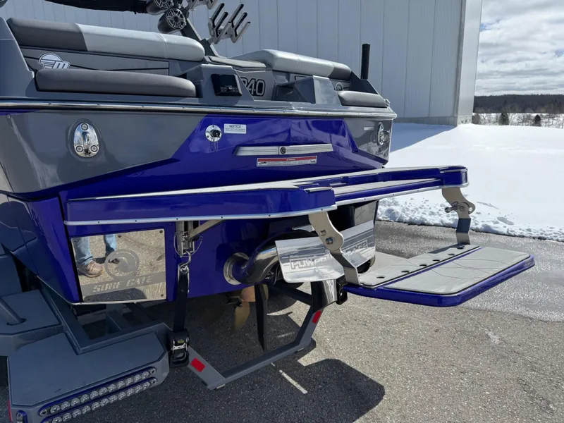 Slide: The Image of 2021 Malibu M240 boat rear view with swim platform and snowy background. - 3