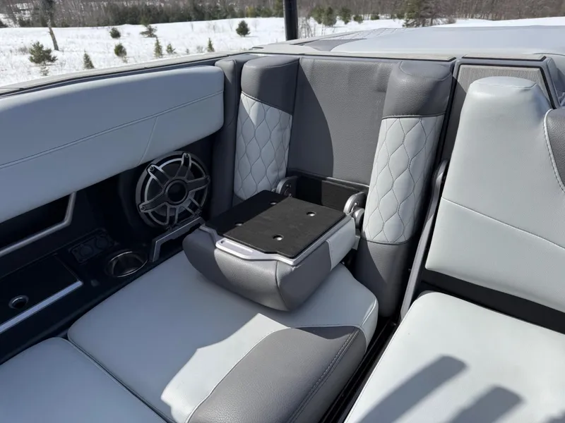 Slide: The Image of 2021 Malibu M240 boat interior with gray seating and speaker system. - 31