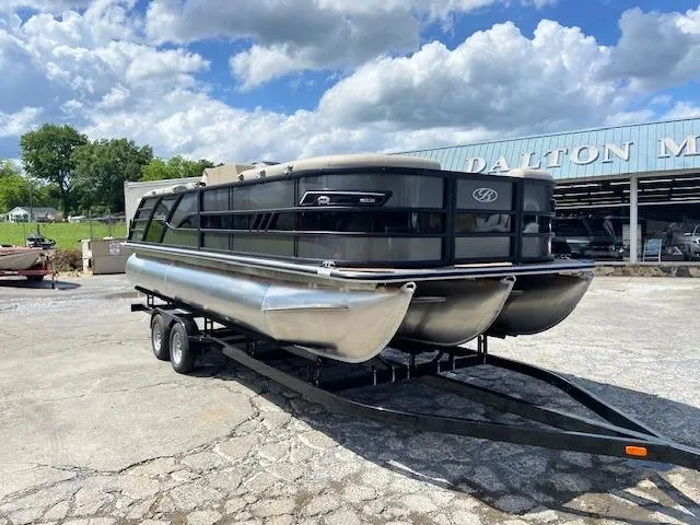 Slide: The Image of 2025 Bentley Pontoons 223 Elite Admiral on trailer, parked outdoors under a cloudy sky. - 1