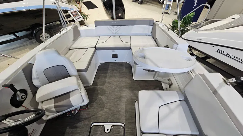 Slide: The Image of 2022 Glastron GTD 180 boat interior with seating and table, showcasing modern design. - 11