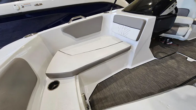Slide: The Image of 2022 Glastron GTD 180 boat interior with gray seating and carpeted flooring. - 13
