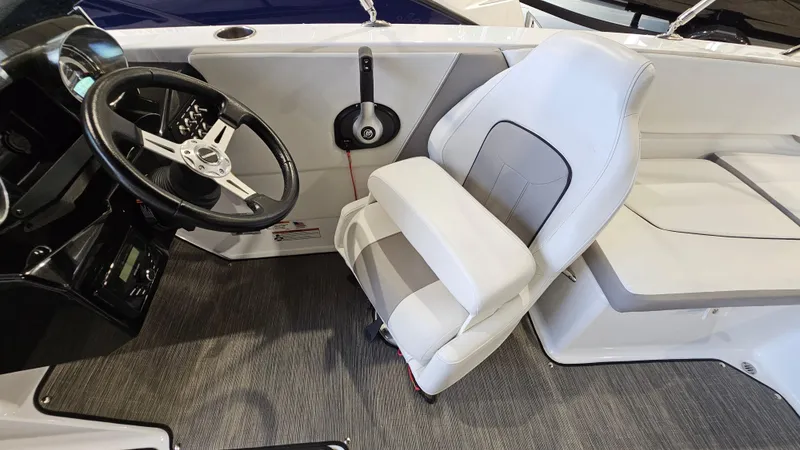 Slide: The Image of 2022 Glastron GTD 180 boat interior with steering wheel and white seating. - 16