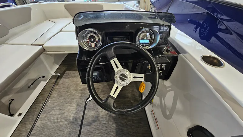 Slide: The Image of 2022 Glastron GTD 180 boat dashboard with steering wheel and gauges. - 17