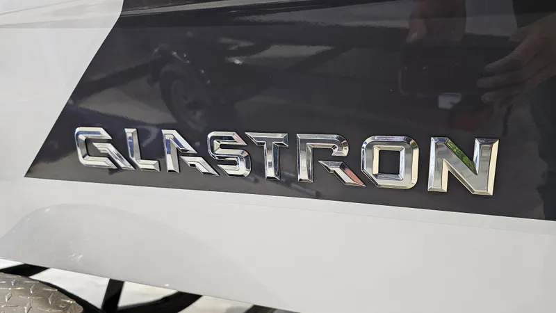Slide: The Image of 2022 Glastron GTD 180 boat logo in chrome on a sleek surface. - 22
