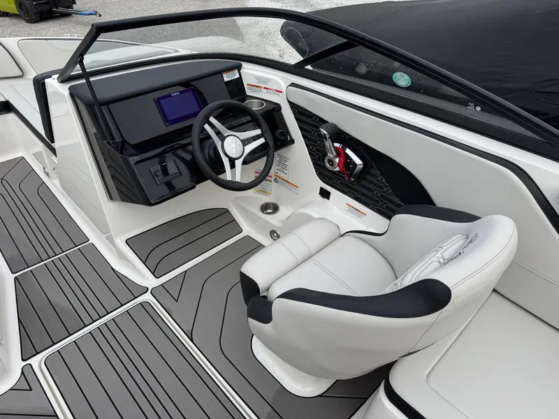 Slide: The Image of 2024 Sea Ray SPX 210 OB boat interior with modern dashboard and steering wheel. - 11