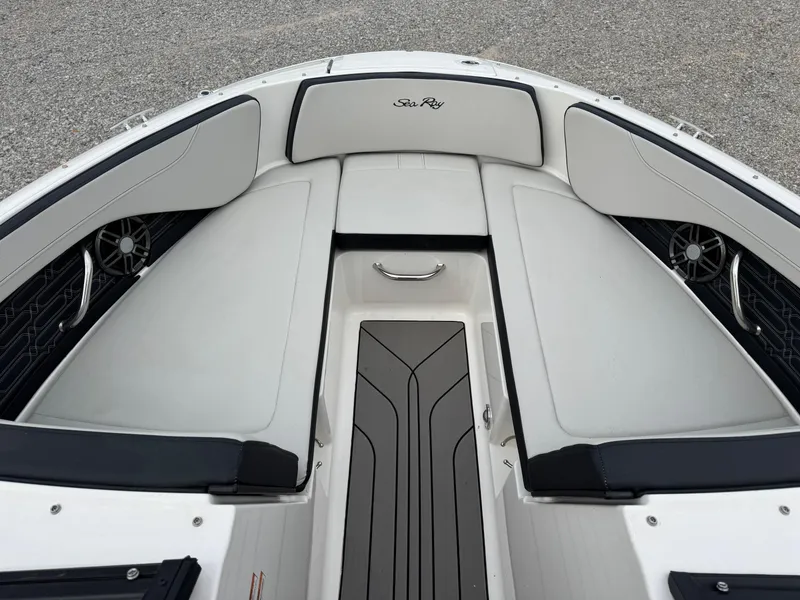 Slide: The Image of 2024 Sea Ray SPX 210 OB boat interior with cushioned seating and sleek design. - 12