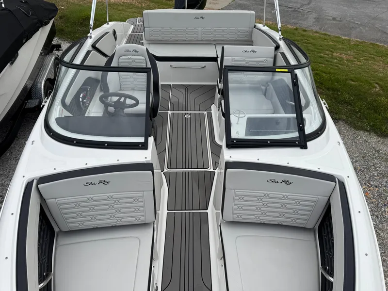 Slide: The Image of 2024 Sea Ray SPX 210 OB boat interior with seating and steering wheel. - 14