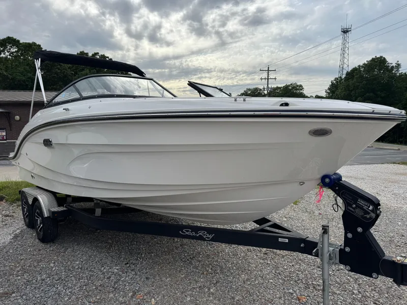 Slide: The Image of 2024 Sea Ray SPX 210 OB boat on trailer, parked outdoors under cloudy sky. - 3