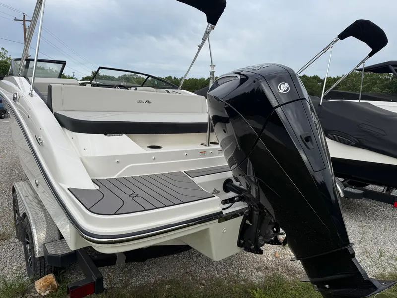 Slide: The Image of 2024 Sea Ray SPX 210 OB boat with outboard motor, parked on a trailer. - 5