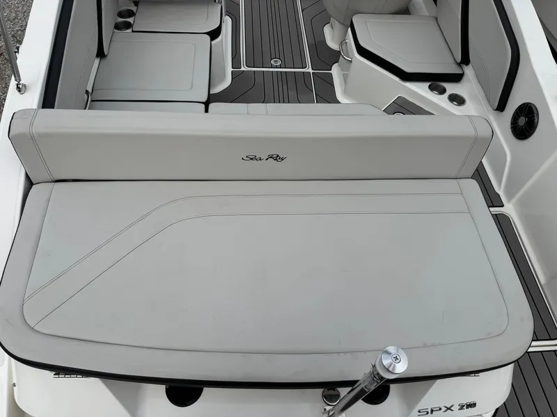 Slide: The Image of 2024 Sea Ray SPX 210 OB boat interior with cushioned seating and sleek design. - 6