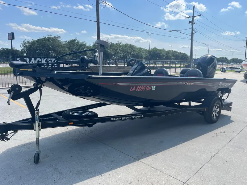 Slide: The Image of 2017 Ranger RT 198P boat on trailer, parked outdoors under a clear sky. - 2