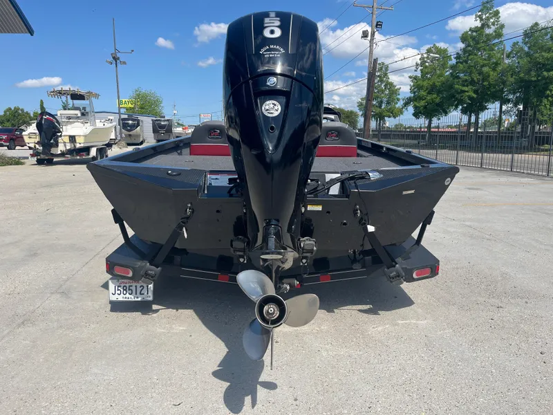 Slide: The Image of 2017 Ranger RT 198P boat with outboard motor, parked outdoors on a sunny day. - 4