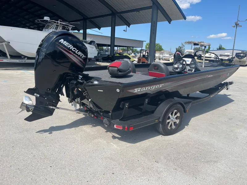 Slide: The Image of 2017 Ranger RT 198P boat with Mercury engine on trailer, parked outdoors under clear sky. - 5