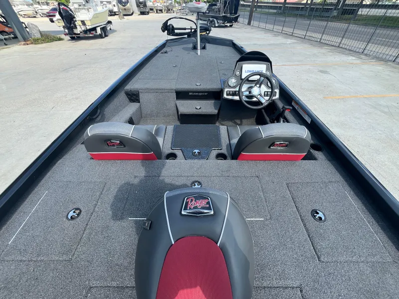 Slide: The Image of 2017 Ranger RT 198P boat interior with steering wheel and seating, featuring gray and red upholstery. - 6