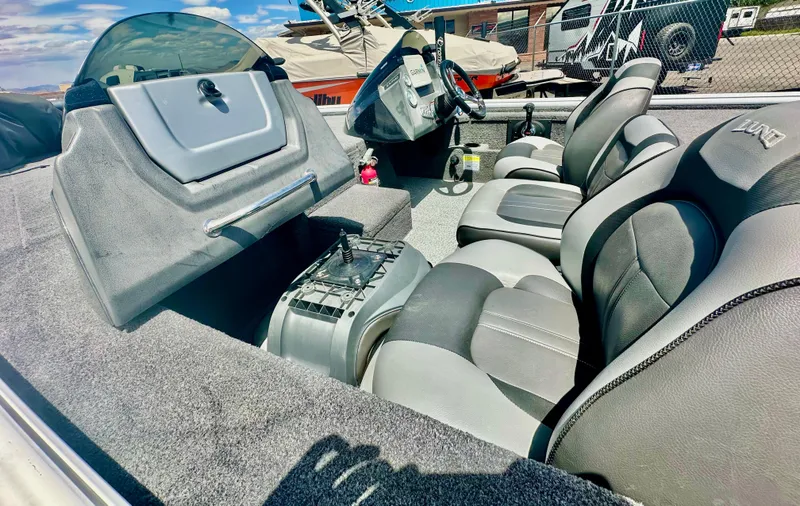 Slide: The Image of 2018 Lund 1875 Pro-V Bass boat interior with gray seating and console. - 11