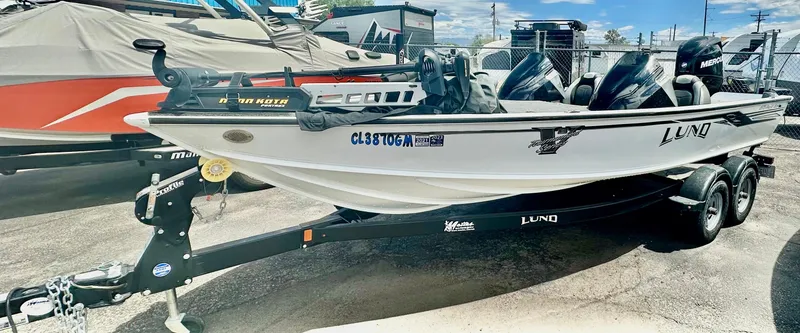 Slide: The Image of 2018 Lund 1875 Pro-V Bass boat on trailer, parked outdoors. - 5