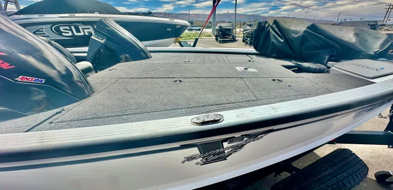 Slide: The Image of 2018 Lund 1875 Pro-V Bass boat, gray deck, parked outdoors under a blue sky. - 7