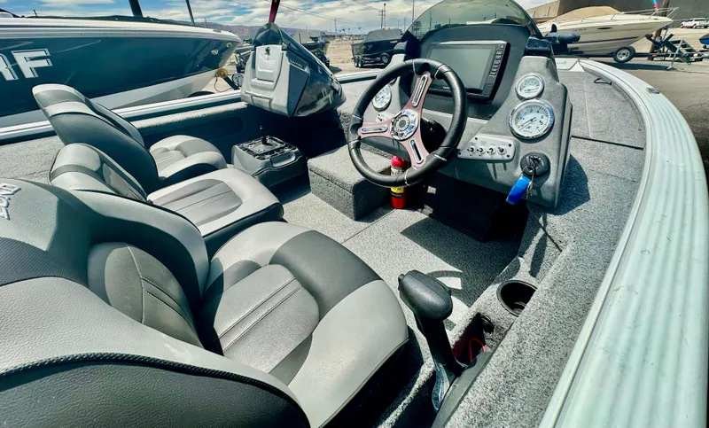 Slide: The Image of 2018 Lund 1875 Pro-V Bass boat interior with steering console and seating. - 8
