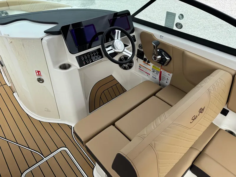 Slide: The Image of 2025 Sea Ray SDX 250 boat interior with tan seating and modern dashboard. - 11